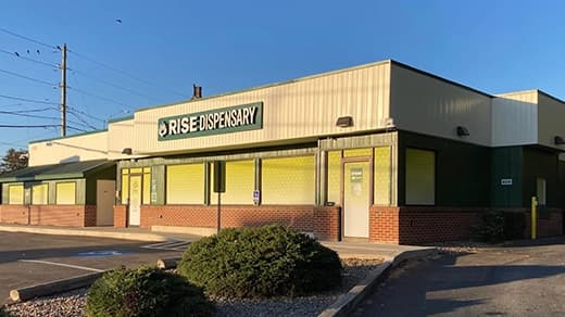 Exterior of RISE Carlisle PA medical marijuana dispensary showing main entrance & parking.
